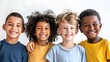 Portrait of four diverse multi ethnic children smiling against a white background