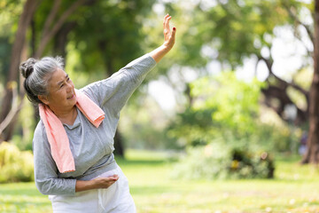 asian senior woman workout and practice tai chi in the park