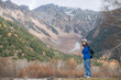 © Jirawatfoto - Elegance in nature, Asian woman in a blue jacket enjoys the journey by the lake. stylish traveler in Japan, capturing the excitement of exploration.