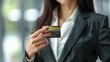 businesswoman holding electronic credit card, closeup of female making secure transaction for retail purchase