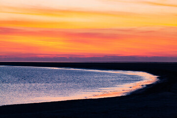 Wall Mural - red sunset over blue sea