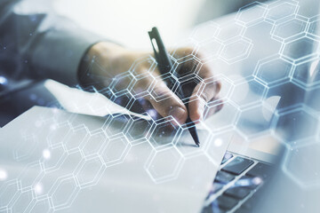 Poster - Double exposure of technology hologram with hexagon and hand writing in notebook on background with laptop. Research and development software concept