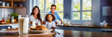 Fototapeta Kwiaty - Happy family having breakfast at home. Focus on the glass of milk, panoramic image with copy space