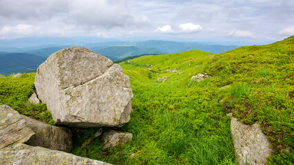 Wall Mural - green alpine hills and meadow of carpathians. stones among the grass beneath a sky with clouds. summ