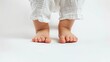 © Emi - Close up of Adorable baby feet isolated on white background. space for text. Banner design. Feet of a newborn baby. Care and raising of children health. Generative ai
