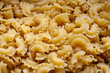 Uncooked Creste di Gallo pasta and ingredients for it cooking