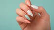 Pastel Nail Beauty - Elegant Female Hand with Multicolored Manicure on Mint Background