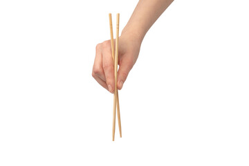 Wall Mural - Female hand holding wooden sushi chopsticks isolated on white background.