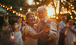 Happy elegant dressed elderly grey-haired couple cheerful smiling when they dancing on 60th Wedding Anniversary ceremony among friends, family relatives on backyard. Happiness of relationships concept