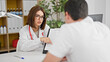 © Krakenimages.com - Doctor and patient having medical consultation showing medical report at the clinic