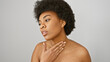 © Krakenimages.com - A contemplative african american woman with curly hair poses against a white background, representing beauty and elegance.