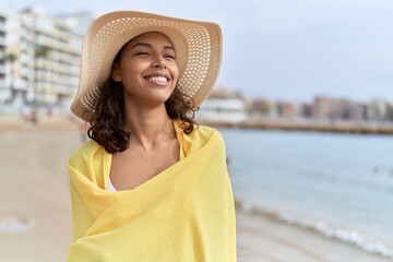 Canvas Print - Young african american woman smiling confident wearing summer hat and bikini at beach