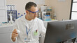 © Krakenimages.com - Hispanic scientist man examines a pill while working in a modern laboratory, depicted in a professional stock image.