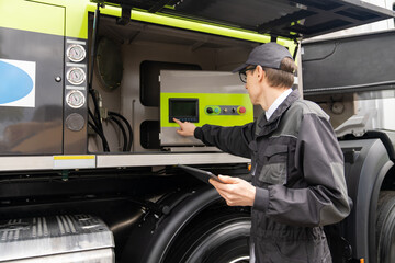 Aufkleber - Worker with digital tablet operating construction machine equipment..