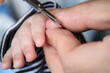 © Dayna - dad clipping baby's finger nails