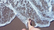 Top View Woman Walks Into The Sea, Sandy Beach In Albania. Summer Vacation. High Quality FullHD Footage