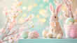 Cute toy rabbit sitting on a podium with Easter eggs and Easter decorations in soft pastel colors against the background of spring flowers