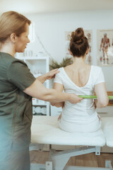 Wall Mural - pensive therapist woman in massage cabinet doing checkup