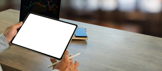 Poster - A businessman holds a mockup. digital tablet with blank screen Mockup replaces your design mockup in the office.