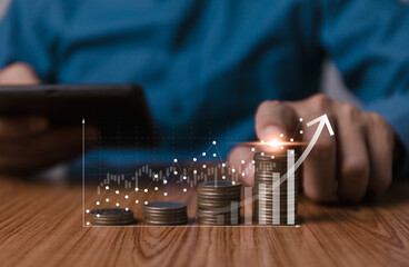 Wall Mural - A person's hands count coins as glowing graph indicates growth, symbolizing financial progress and digital investment analysis. Coins money stacking with up arrow and percentage symbol for financial.