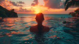 Fototapeta  - Paradise luxury resort honeymoon getaway idyllic Caribbean tropical hotel, a woman silhouette swimming in infinity pool watching sunset serene getaway at dusk