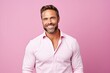 © Inigo - Portrait of handsome smiling man in pink shirt, isolated over pink background.