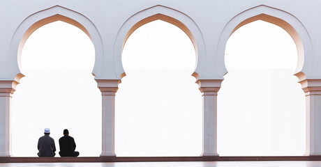 Wall Mural - two men sitting and talking with their backs to the camera under the mosque building for background. design for text