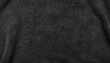Black plush fleece fabric texture background , background pattern of soft warm material with copy space for text