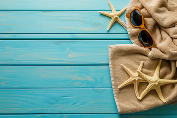 Wall Mural - Summer background towels with sunglasses and starfish on blue wooden, Flat lay top view