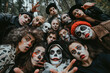 Selfie of group of people of different ages looking into camera, dressed in halloween costumes and make-up