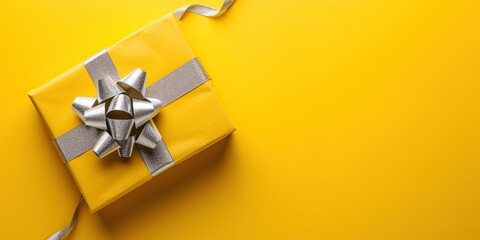 Yellow gift box with ribbon. Copy space background