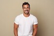 Portrait of handsome young man in white t-shirt on beige background
