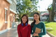 © crizzystudio - University student. Two Asian college girls enjoying conversation Say hello after class using your laptop and notebook to happily research together.