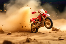 A Vibrant Red Miniature Motorbike Zooming Through A Sandy Playground, Leaving A Trail Of Dust Behind.