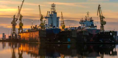 Wall Mural - Ship repair at the ship repair yard during a spectacular sunrise