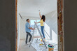 © Westend61 - Young couple installing light bulb at new home