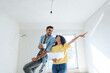 © Westend61 - Happy couple with blueprint planning for renovation in new home