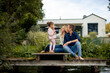 © Westend61 - Smiling man and woman with daughter on jetty