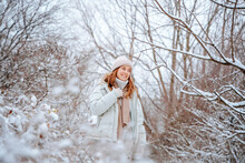 Smiling Woman Spending Leisure Time Amidst Frozen Trees In Winter