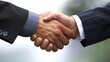 © Matthew - Two hands of businessmen shaking hands, symbolizing successful negotiations for a business merger and acquisition, showcasing teamwork