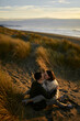 © Westend61 - Young woman kissing boyfriend on beach