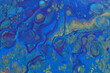 art photography of abstract marbleized effect background with blue and gold creative colors. Beautiful paint.