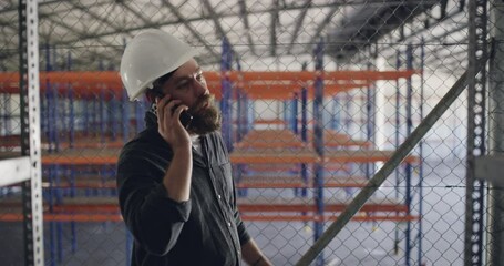Poster - Engineer, man and phone call at factory, conversation and storage of inventory. Smartphone, warehouse and contractor talking to building maintenance, communication technology and shipping logistics