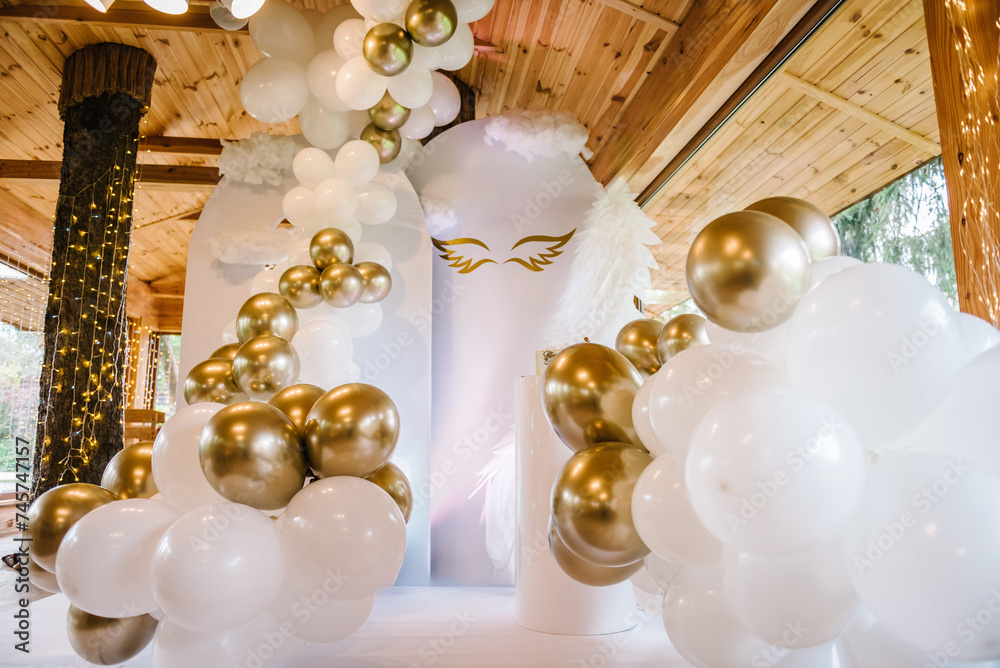 Photo wall decoration of angel wings and white and gold balloons in ...