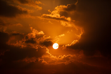 Wall Mural - sun at sunrise time at the morning in warm color tone. with clouds.