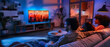 © javu - Young couple watching a movie on tv at home in the evening.