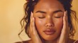 © Z A C - A woman with closed eyes resting her hands on her cheeks in a serene and peaceful pose.