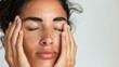 © iuricazac - A woman with closed eyes resting her hands on her face showcasing a serene and peaceful expression.