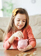 © Lumos sp - child saving money girl bank finance investment coin happy save wealth young piggy cash kid little economy financial childhood banking pig piggybank home family cute future currency