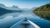 Fototapeta Do pokoju - Enjoy in river under mountain, view from the bow of a small wooden boat to the calm lake and mountain landscape